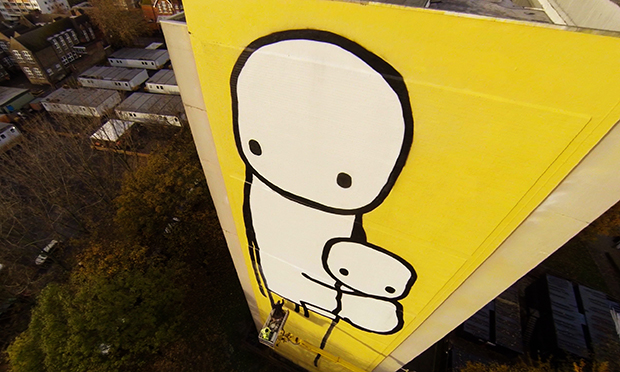 Tall order: Stik puts finishing touches to Big Mother mural