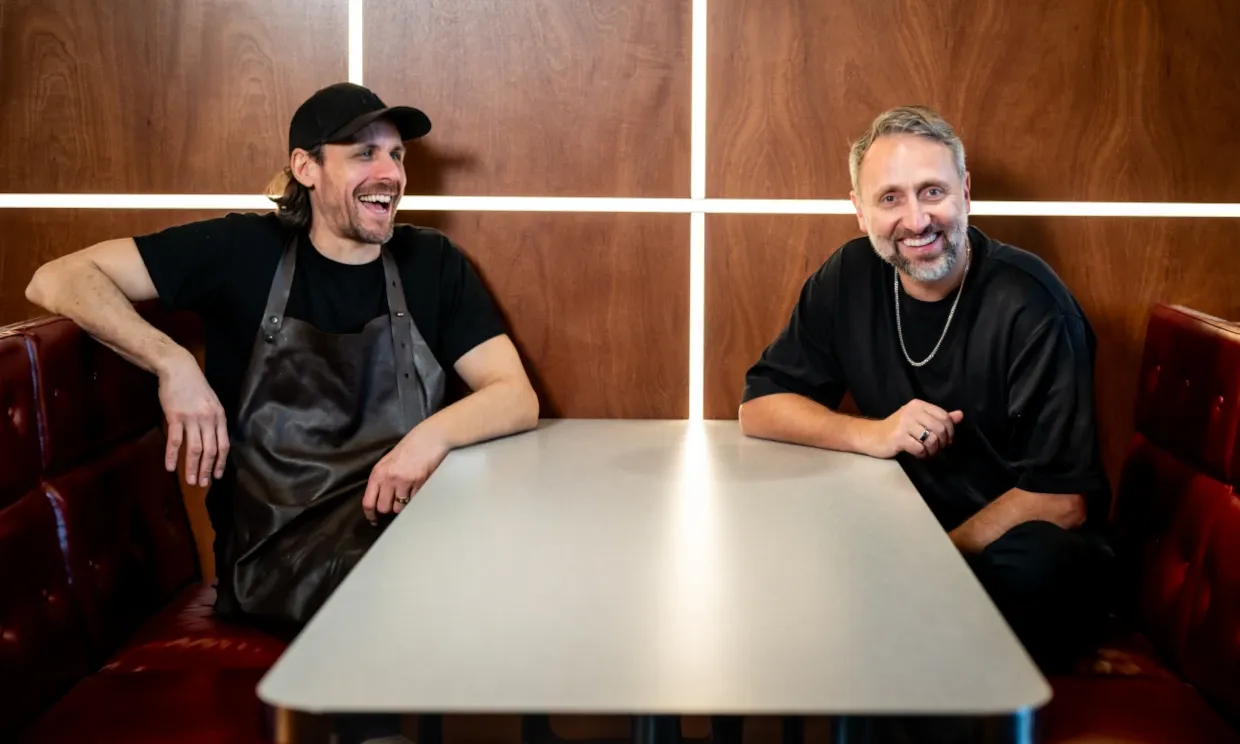 Owners Jamie and Ronnie smiling while sat one of the tables.