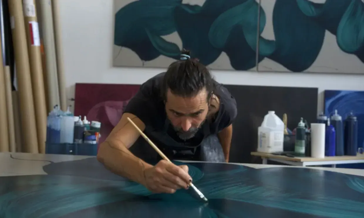 Kostas Papakostas painting with a small brush on canvas.