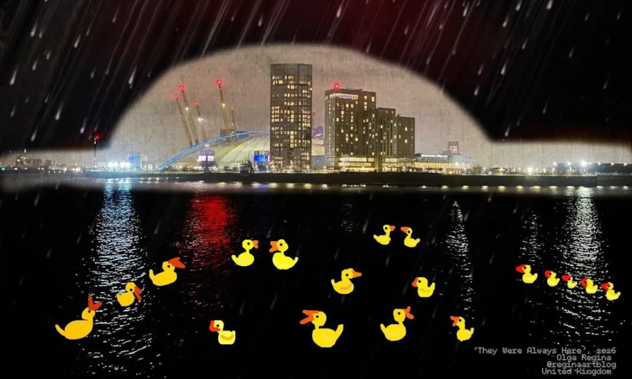 A photograph of Docklands illuminated at night. Lots of animated yellow rubber ducks float in the dark water.