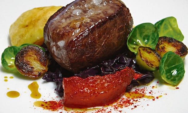 Roast loin of venison with braised red cabbage and sprout tops. Photograph: Patricia Niven