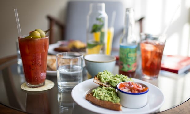 Smashed avocado with fresh chillies and sunflower seeds on pan de coca